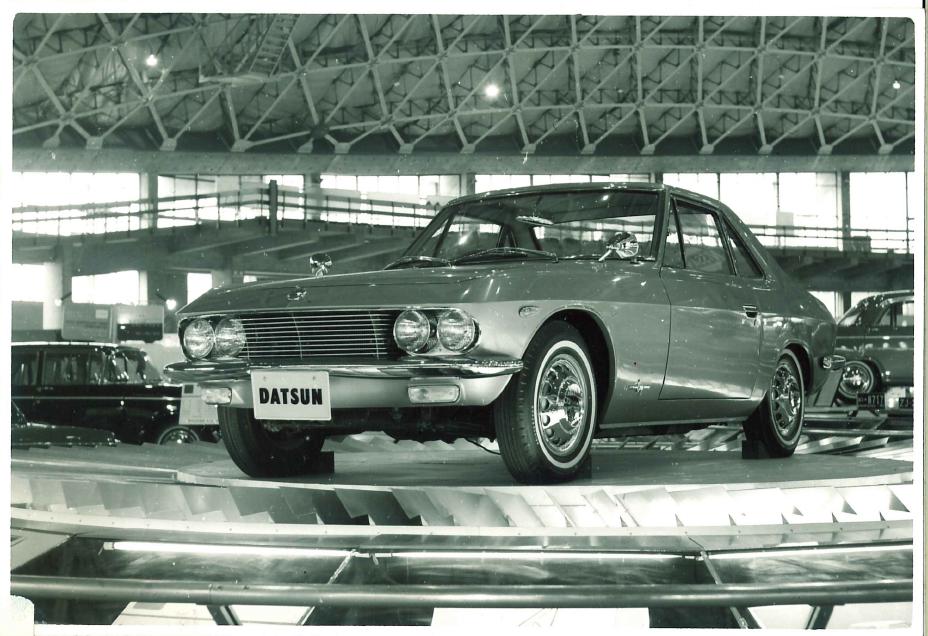 Front view of the 1964 Datsun coupe 1500 on display at an auto show.