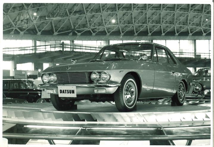 Front view of the 1964 Datsun coupe 1500 on display at an auto show.