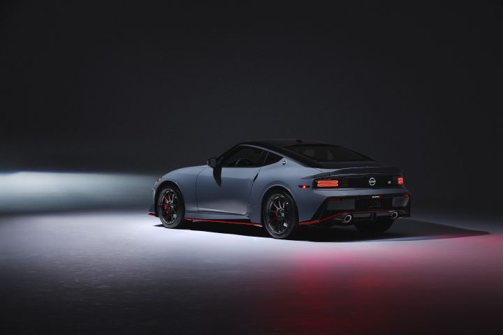 Nissan Z NISMO three-quarter view in darkly light gallery with car lights on