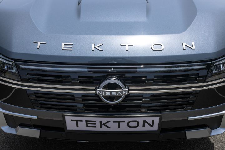 Close-up view of the Nissan Tekton front grille and bonnet lettering with Nissan and Tekton badging.