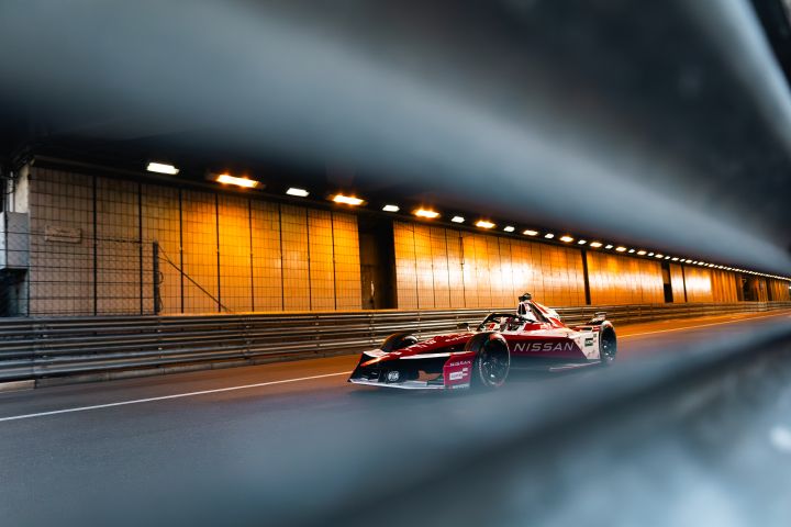Seitenansicht von Norman Nato im Nissan Formula E Rennwagen mit der Startnummer 23, aufgenommen durch die Leitplanken im Tunnel von Monaco.