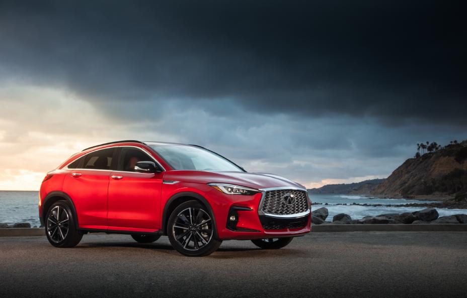 The all new 2022 QX55 in Dynamic Sunstone Red next to the ocean