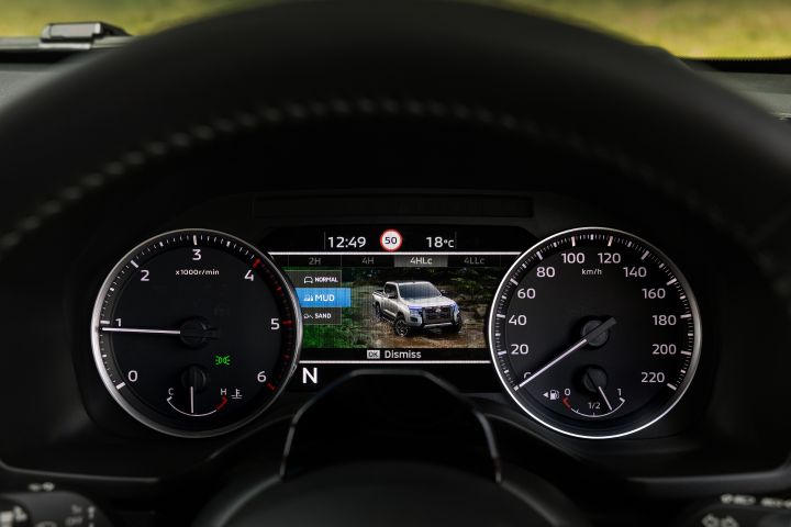 2026 Nissan Navara PRO-4X finished in Boulder Grey showing the drive-mode screen with MUD selected, illustrated vehicle scene and terrain options list.