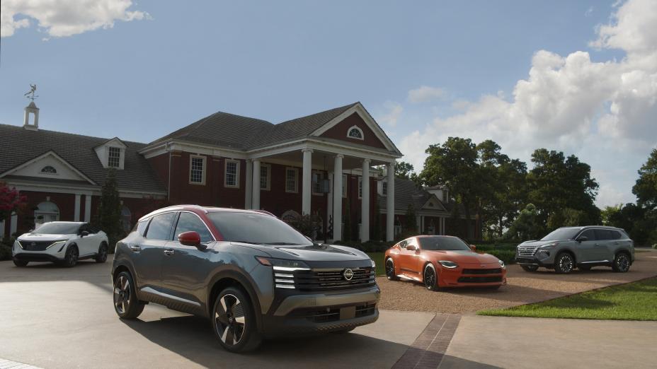 A Nissan Ariya, Kicks, Z and Rogue parked in front of a large colonial building with blue skies behind.