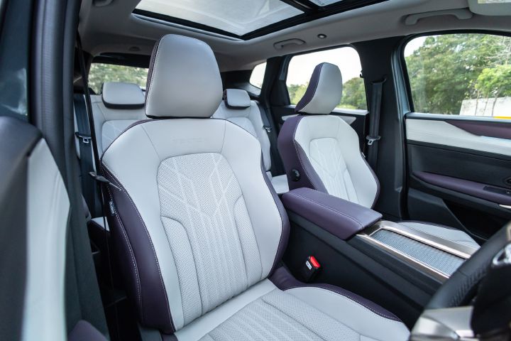 Angled view of the Tekton’s front seats, centre console and panoramic roof.