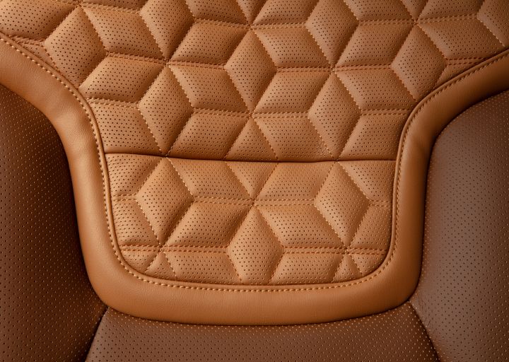 Close up of the quilted stitching on the tan interiors seats inside the 2025 Nissan Armada.