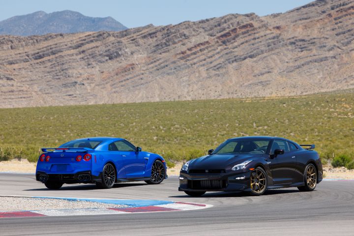 Two 2024 GT‑R Special Editions, blue on left and black on right, on a track with a mountain in the background