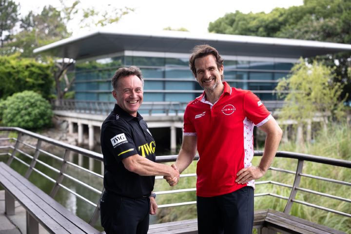 Landscape image of Tommaso Volpe, managing director and team principal, Nissan Formula E Team and Roger Griffiths, Team Principal, Andretti Formula E shaking hands and smiling.