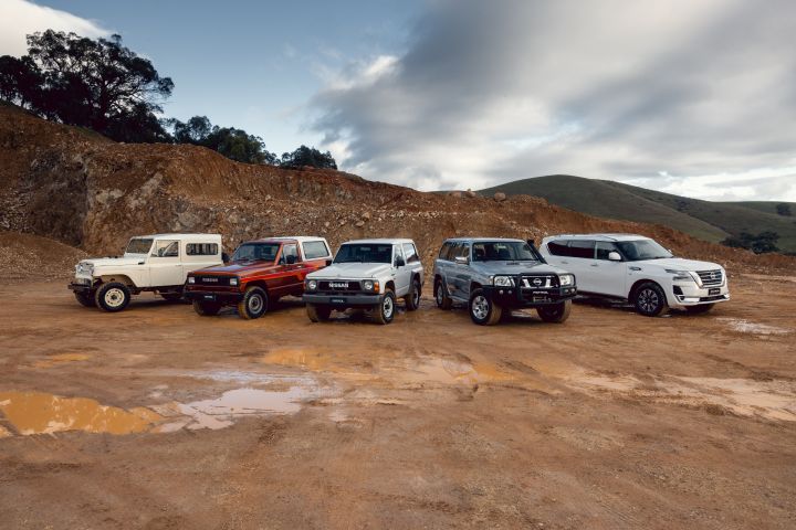 Nissan Patrol generations finished in various colours elevated hero exterior lineup with modern black Patrol in foreground and heritage models behind