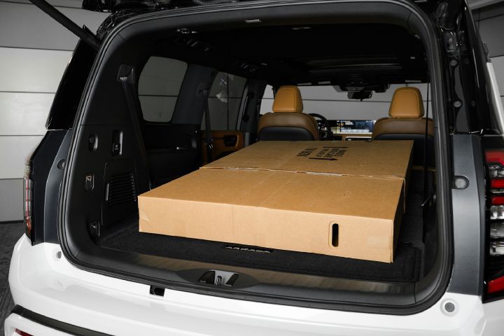 A 65-inch television inside the back of a 2026 Nissan Armada with the second and third row seats folded down.