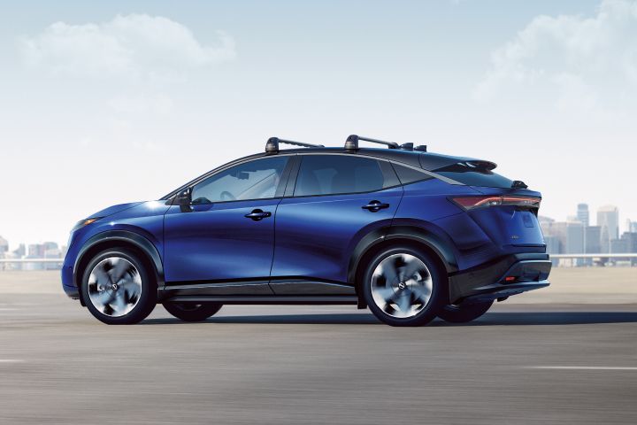 A blue 2024 Nissan Ariya profile driving toward the left.