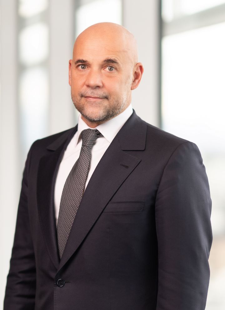 Portrait of Guillaume Cartier (suit, tie and NISSAN corporate pin)
