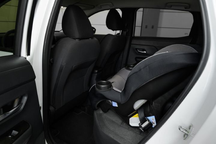 An infant car seat positioned front-facing inside the 2026 Nissan Kicks.