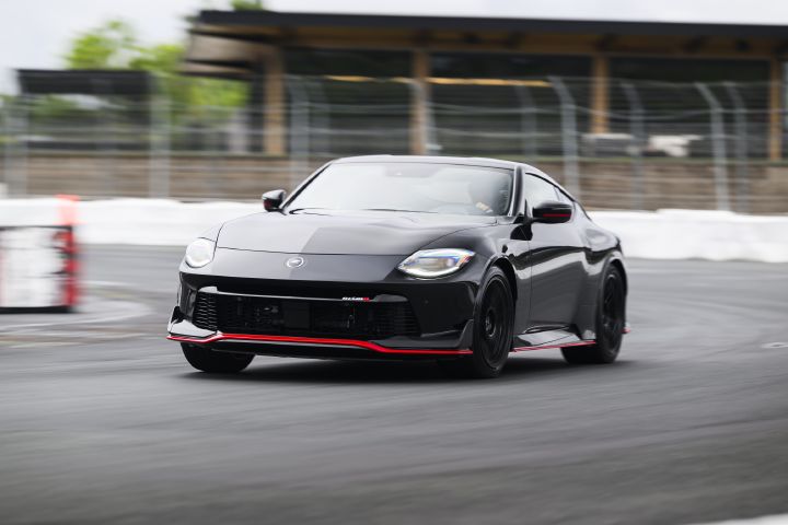 A 2027 Nissan Z NISMO Manual Transmission curving around the racetrack.