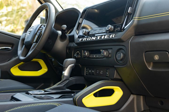 Close up of the dashboard display and yellow details inside the 2027 Nissan Frontier Sport Edition.