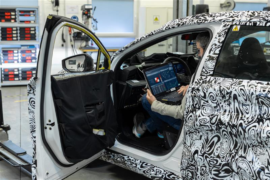A Nissan engineer seated in a test vehicle working on a laptop using Monolith AI software.