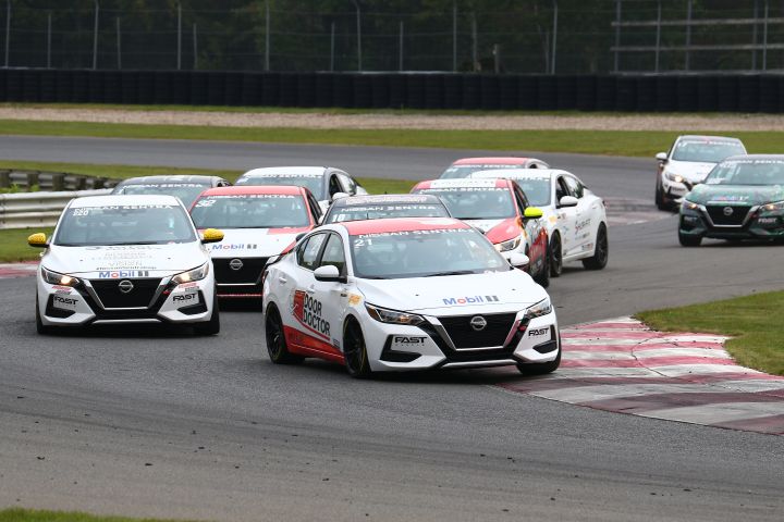 Group of Sentra Cup cars rounding a corner.