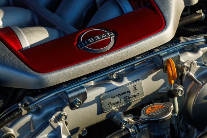 Close-up of the red and silver VR38DETT engine that sports handcrafted badge inside the 2024 GT‑R Skyline.