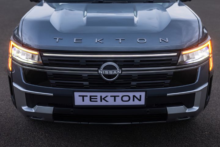 Close-up front view of the Nissan Tekton with illuminated LED lighting and prominent grille design