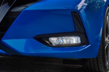 A zoomed in view of the front fog light on a blue 2020 Nissan Sentra