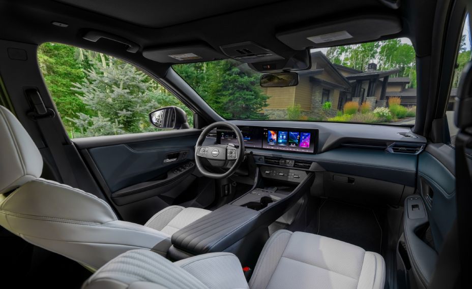 The 2027 Nissan Rogue Hybrid SR steering wheel, dashboard and windshield as viewed from the front passenger seat.