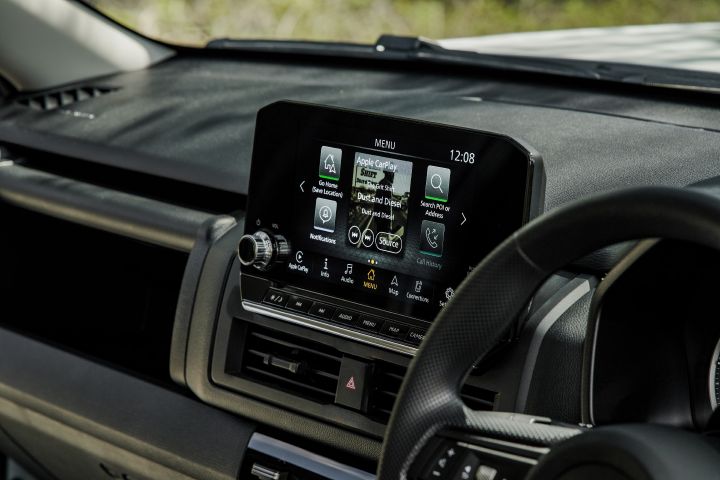 2026 Nissan Navara SL dual cab ute finished in Alpine White featuring a close view of the infotainment screen with navigation, Apple CarPlay and dashboard controls.