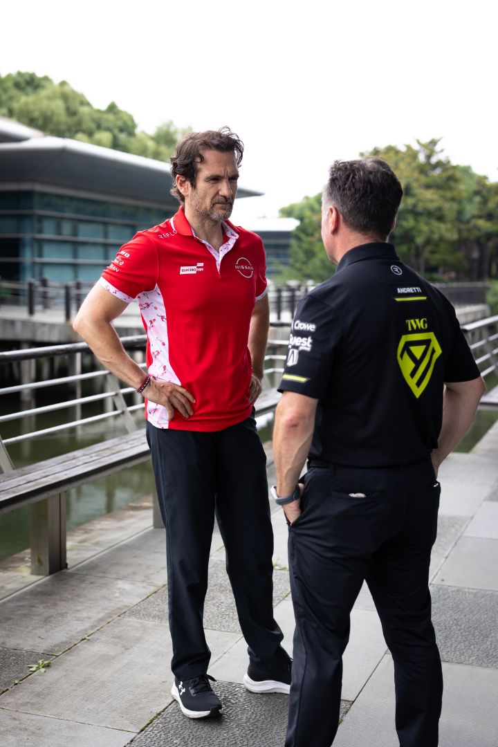 Foto im Hochformat von Tommaso Volpe, Geschäftsführer und Teamchef des Nissan Formula E Teams, und Roger Griffiths, Teamchef von Andretti Formula E, wobei Volpe die Hände in die Hüften gestemmt hat und Griffiths der Kamera den Rücken zukehrt.