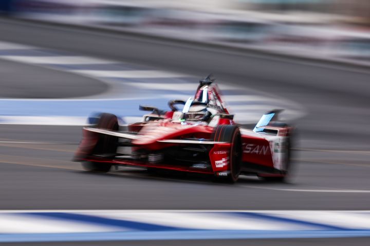 Speed shot of Oliver Rowland in Mexico City driving his Nissan Formula E Team from a front/side angle.