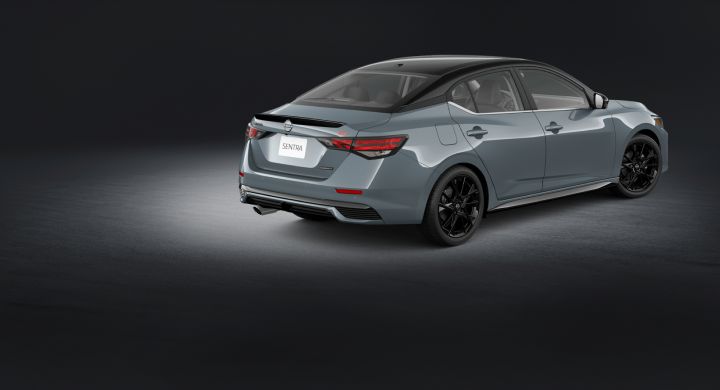 Rear angled view of the Sentra Midnight Edition in a virtual gray room with a spotlight overhead.