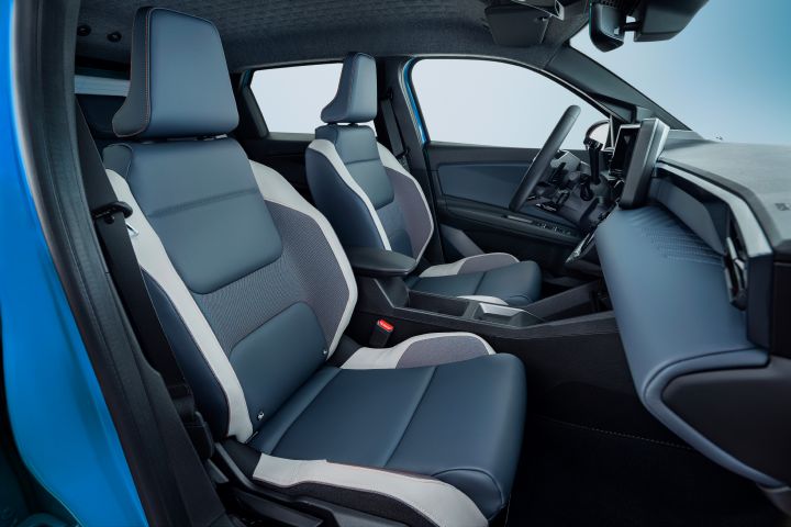 Side view of Micra front seats from passenger side door pov revealing leather materials, steering wheel and dashboard