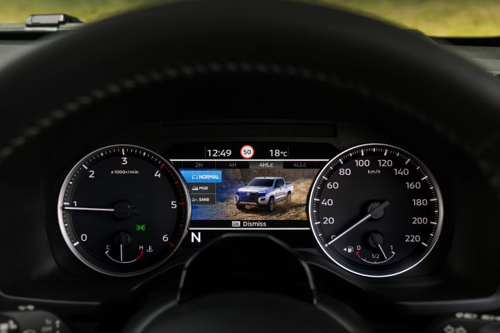 2026 Nissan Navara PRO-4X finished in Boulder Grey showing the off-road mode menu with NORMAL selected and a vehicle graphic in the background.