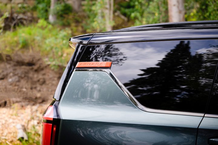 Close up of the red Armada logo near the top of the side rear window above the taillights on a gray 2025 Nissan Armada.
