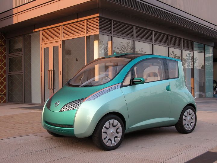 Teal Nissan Effis parked in front of a building