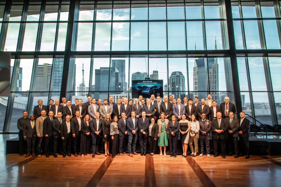A large group of people in business attire standing together for a photo.