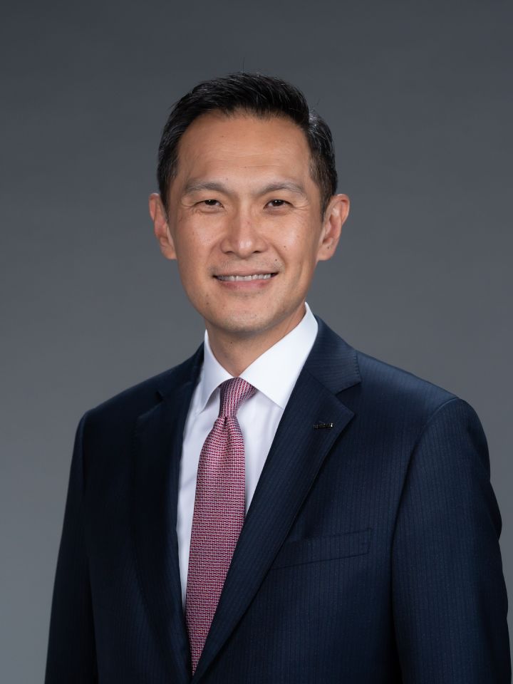 Portrait of Stephen Ma (suit, tie and NISSAN corporate pin) (smiling)