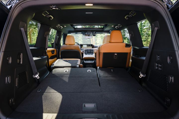 View of the interior from the open hatch back of a 2025 Nissan Armada, the cargo space and folded rear seat can be seen.