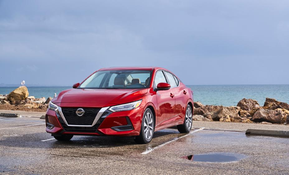 The red 2020 Sentra Ride is parked in front of the ocean.