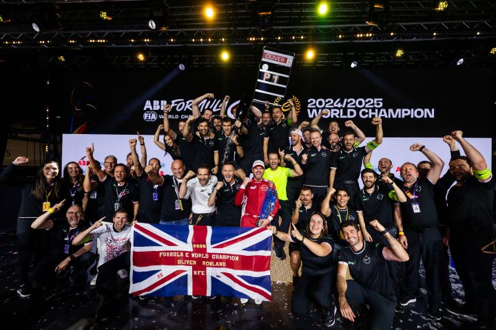 A group photo of the team celebrating after Oliver Rowland's trophy presentation.