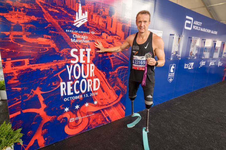 Nissan Ambassador Richard Whitehead poses with his finishers medal at the 2024 Chicago marathon landscape image