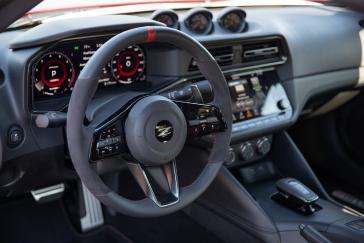 Interior enhancements to the 2024 Nissan Z NISMO include red-anodized engine-start and drive mode buttons, manual-adjust Recaro seats and a leather and Alcantara-wrapped steering wheel with a red marker at the 12 o’clock position.