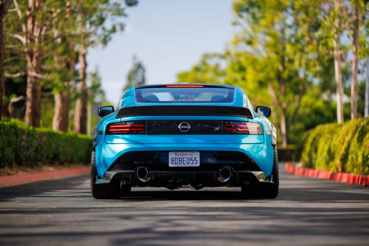 Rear view of the Nissan Z Kaze Concept, trees line the road.