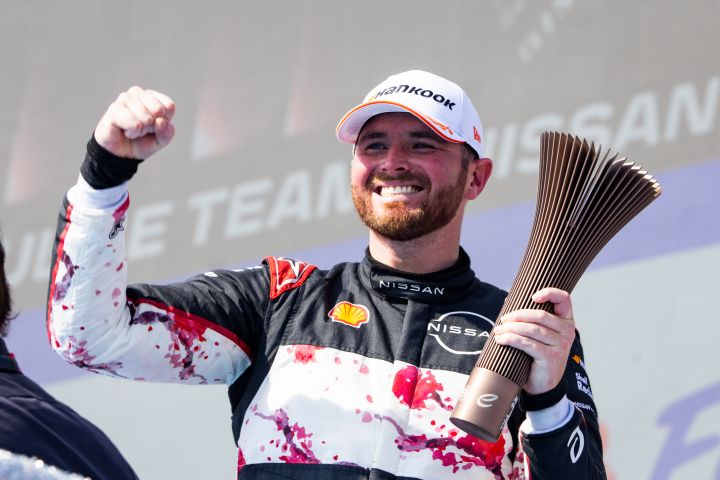Oliver Rowland celebrates on the podium