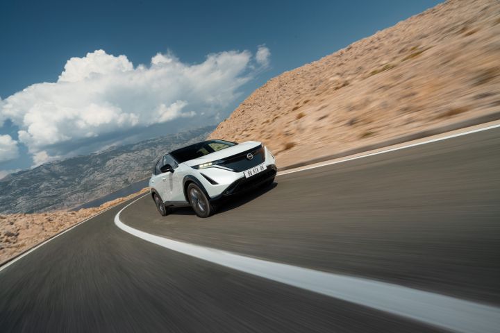 White Ariya driving through mountains