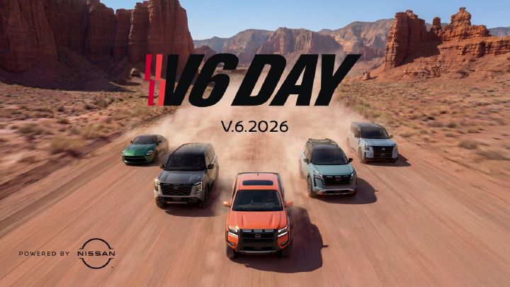 Five Nissan vehicles driving on a desert road in an arrow formation, "V6 Day" is written in text above the vehicles.