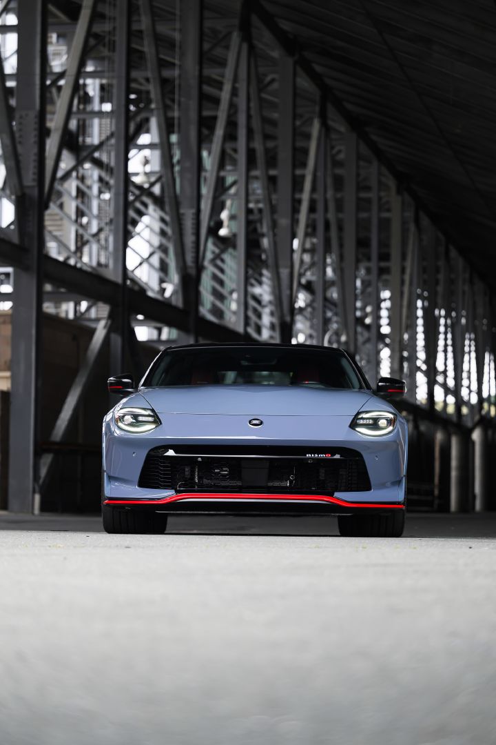 Front view of the 2027 Nissan Z NISMO Manual Transmission parked near stadium seats.
