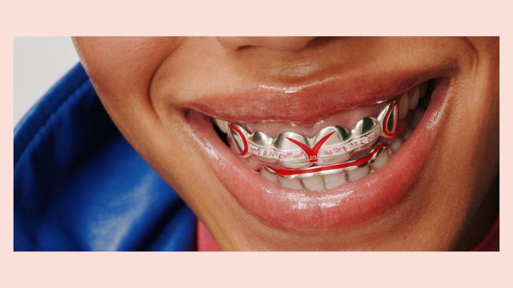 Gros plan d'un grillz métallique argenté personnalisé inspiré de l'univers Formula E Nissan.