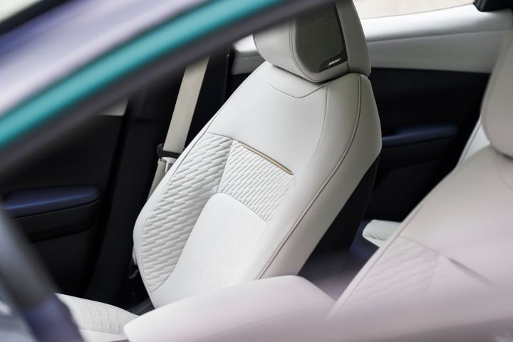 The front interior seats viewed from the driver's window on the 2026 Nissan LEAF.