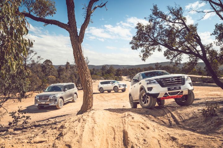Three Nissan Patrol 4x4 cars parked outside in the Australian Outback