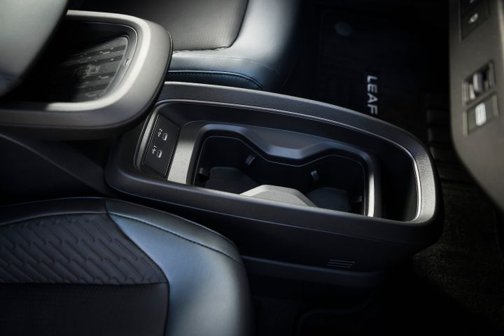 Close up of the center console area and cupholders inside the 2026 Nissan LEAF.
