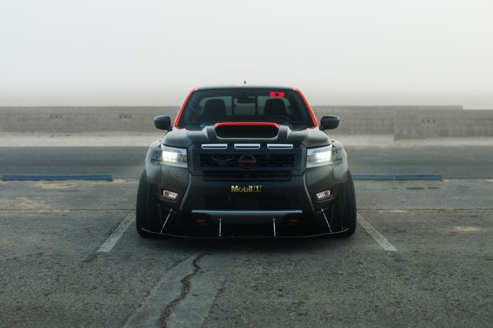 Front view of the Nissan Frontier Tarmac, parked in a lot on a foggy day.